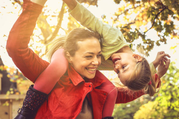 istock Mom gives a ride on piggyback. 866954996