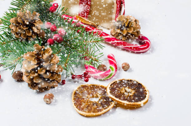 istock Gift box tied with a red ribbon , fir branches,candy 866955178