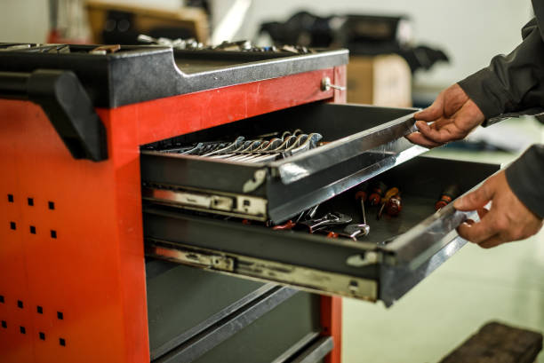 istock Mechanic looking for some tools for work at an auto shop. 866955192