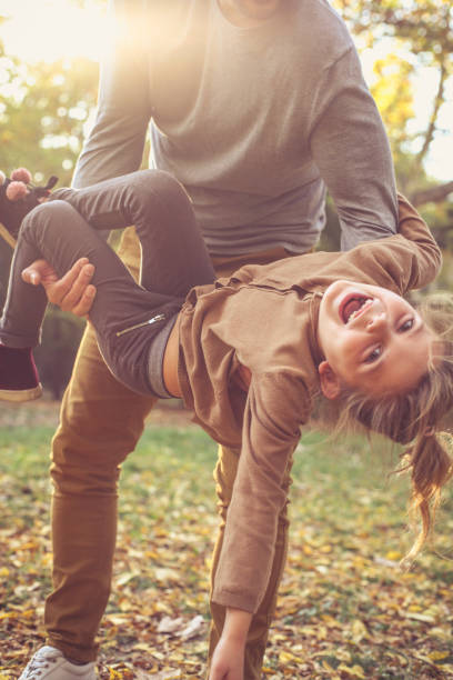 istock Father playing with daughter, carrying her in arms. 866955852