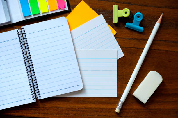 istock Blank notebook with pencil on brown wood table 866958644