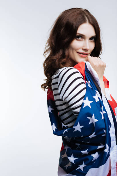 istock Gorgeous young woman posing with American flag 866959462