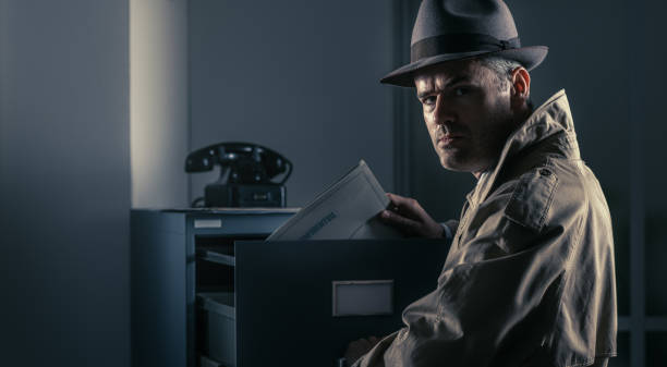 istock Vintage spy stealing files in the office 866962248