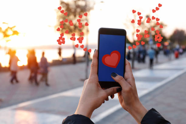 istock Hand holding smart phone with sending heart 866962280