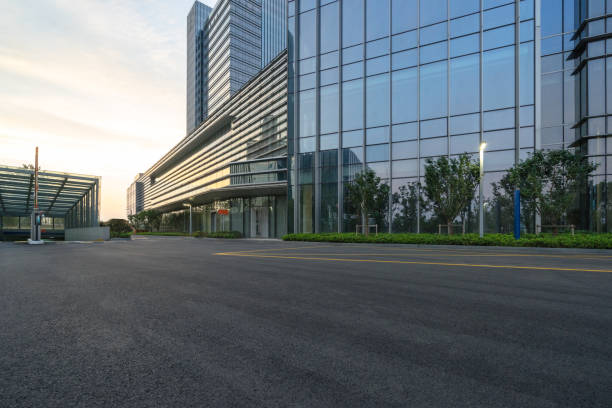 istock modern glass building with empty asphalt road 866966512