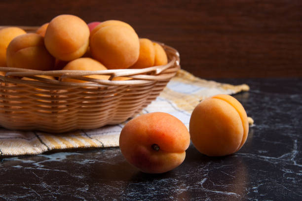istock Group of harvested apricots in basket. 866972502