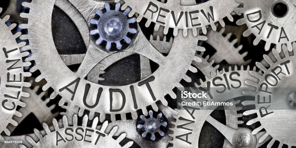 Metal Wheel Concept Macro photo of tooth wheel mechanism with AUDIT, ANALYSIS, REVIEW, DATA, REPORT, CLIENT and ASSET words imprinted on metal surface Audit Stock Photo