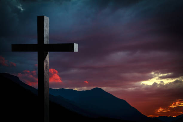 istock Jesus Christ cross on a background with dramatic sky, mountain sunset 866975978