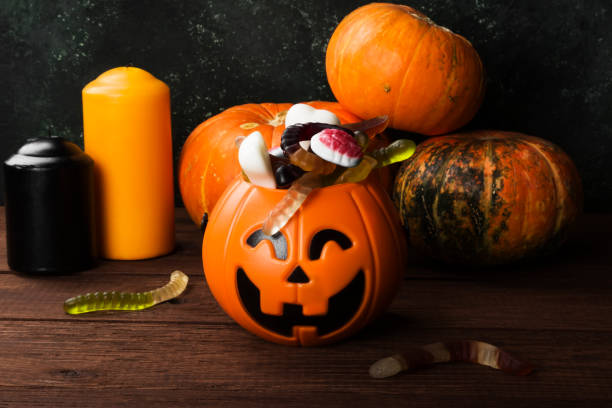 istock Terrible sweets for Halloween in decorative pumpkin on a dark background 866979108