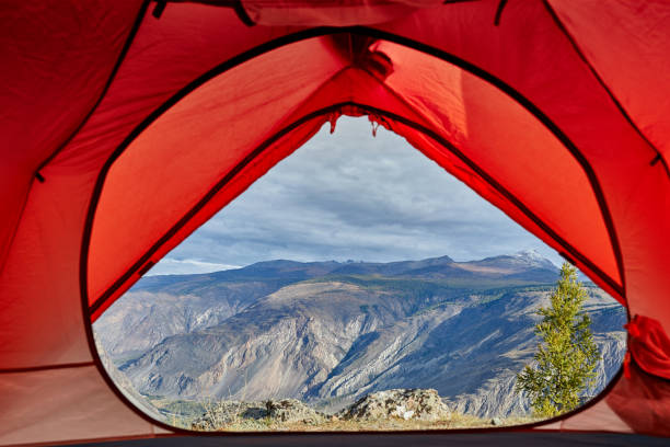 istock Looking out of open tent door upon calm river 866979390