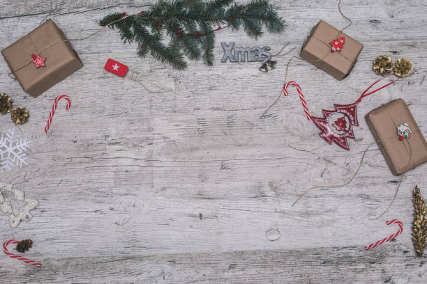 istock Christmas gift box and fir tree branch on wooden table. Top view with copy space 866981232