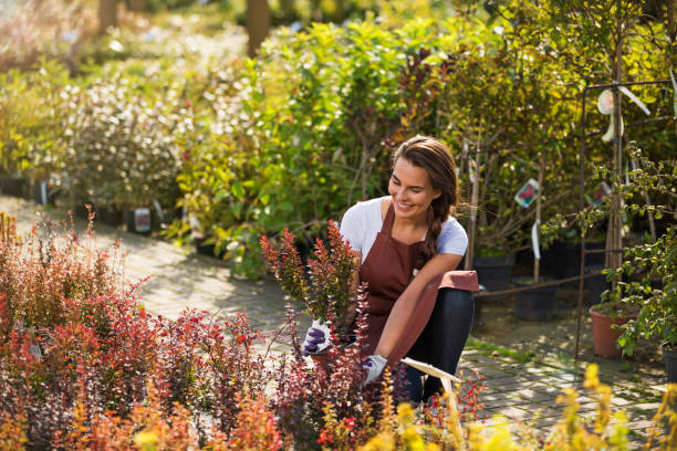 istock Smiling employee in garden center 866986330