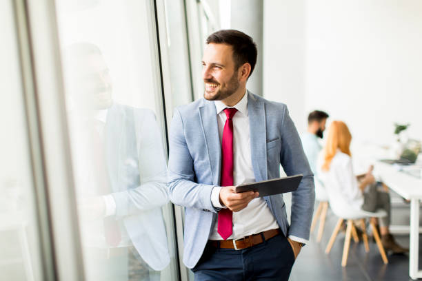 istock Young businessman with digital tablet in office 866986570