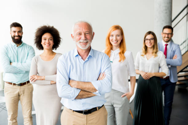 istock Young business people with senior colleague 866987984