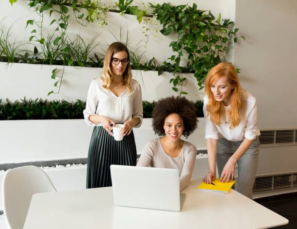 istock Three young businesswomen in the office 866988112
