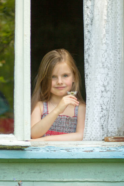 istock Beautiful lgirl looking  in window 866990822