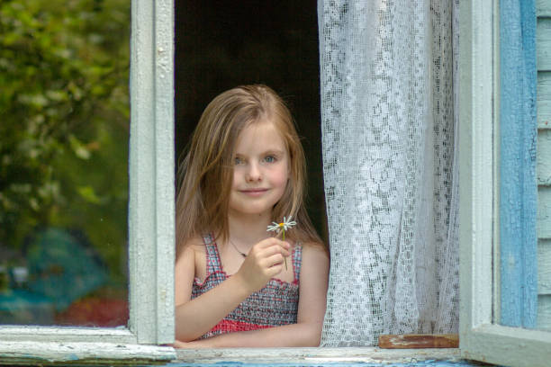 istock Beautiful lgirl looking  in window 866990832