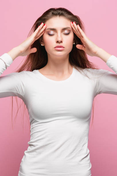 istock Portrait of beautiful young brunette with bare shoulders touching her temples feeling stress 866994886