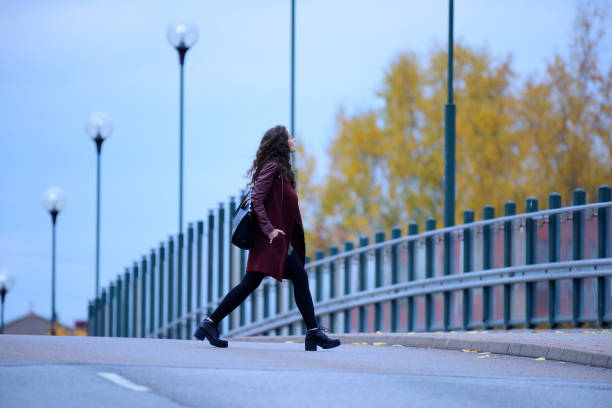 istock Woman walking home on dark bridge 866995236