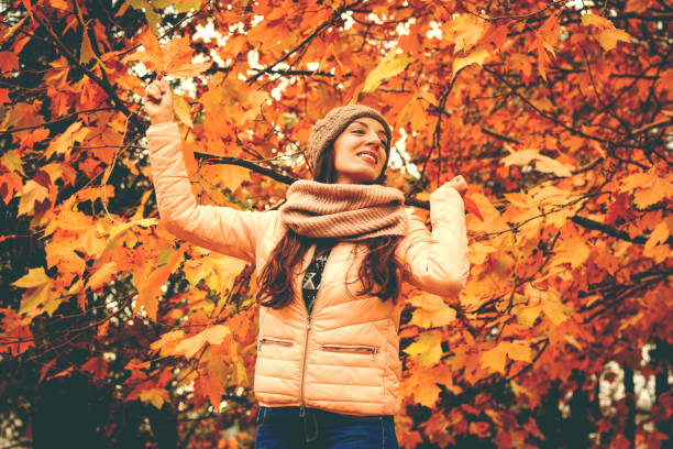 istock Beautiful lady surrounded autumn leaves 866998290