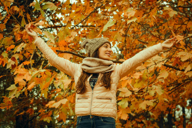 istock Beautiful lady surrounded autumn leaves 866998304