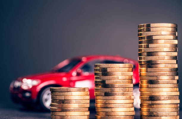 Rising car costs Rising stacks with coins and a red car in the background car insurance stock pictures, royalty-free photos & images