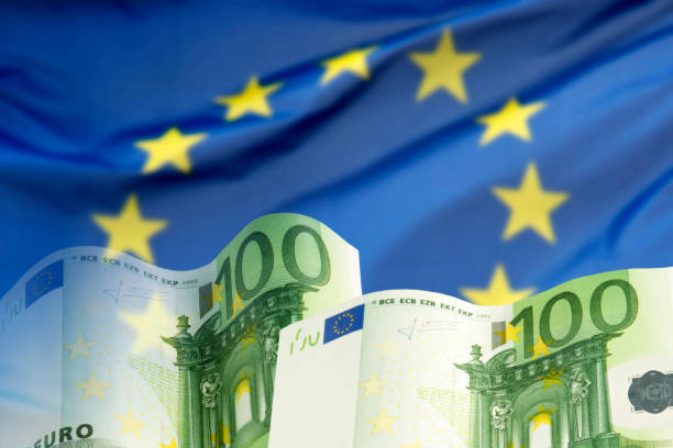 istock Euro banknotes and European flag 867003394