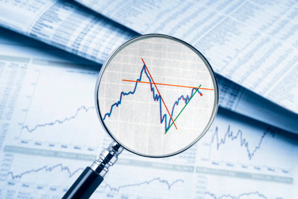 istock Magnifying glass shows a share price 867003486
