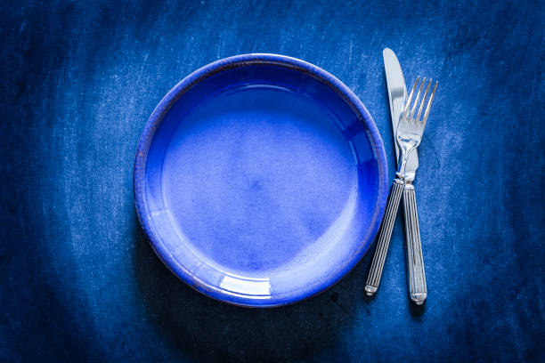 istock Blue toned place setting shot from above on dark background 867006266