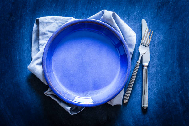 istock Blue toned place setting shot from above on dark background 867006706