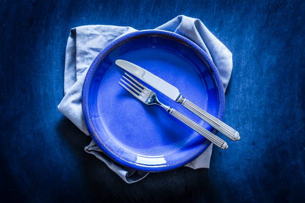istock Blue toned place setting shot from above on dark background 867006710