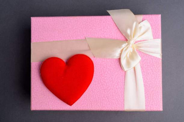 Studio Shot Of Gift Box With Red Heart Against Gray Background