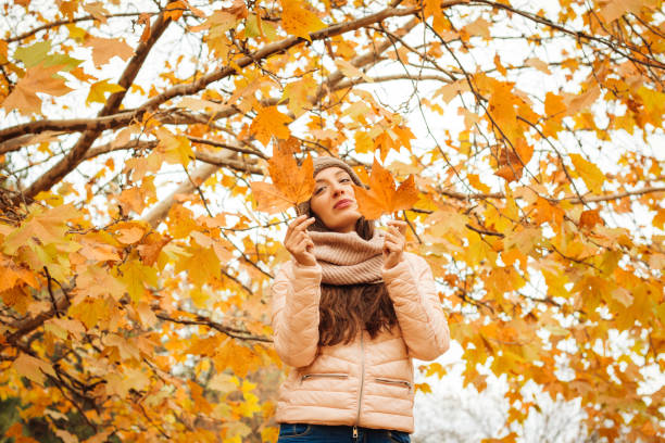 istock Beautiful lady surrounded autumn leaves 867010526