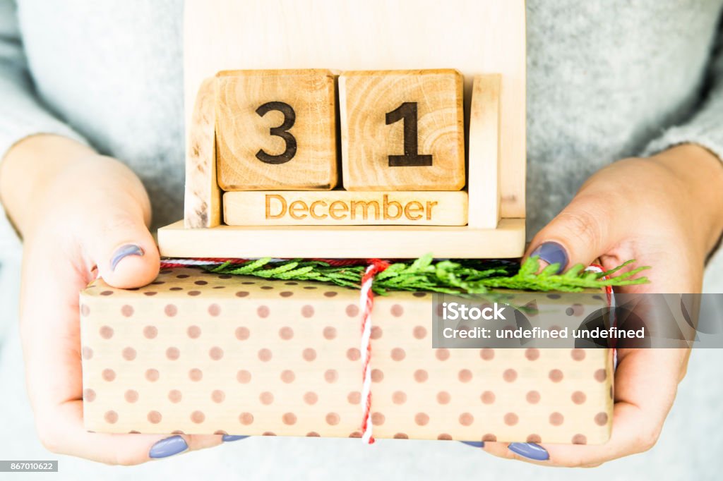 woman holding a wooden calendar with the date of New Year's Day December 31 2018 Stock Photo