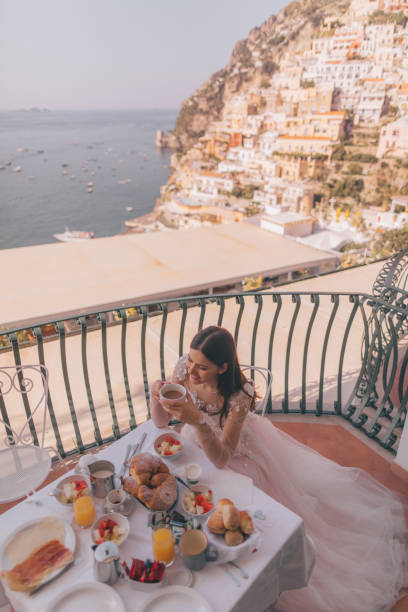Breakfast with a view Photo of a beautiful bride having breakfast on the terrace with a view of amazing Positano, Italy amalfi food stock pictures, royalty-free photos & images