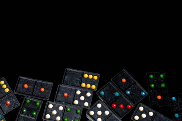 istock Domino figures are spread on black reflective background 867011346