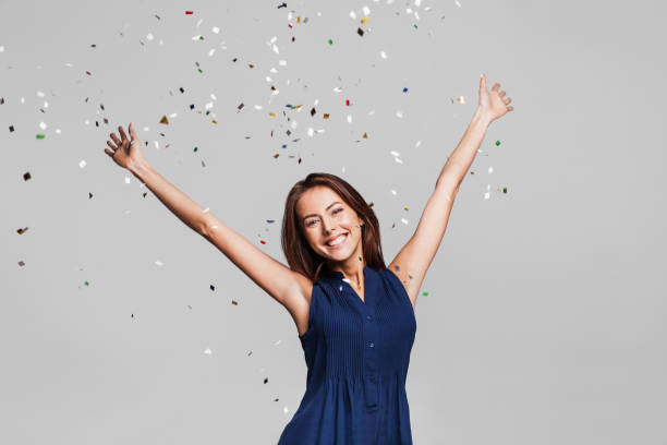 istock Laughing girl with falling confetti at party 867011774