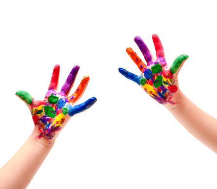 Boy with colour paint on his hands isolated on white background