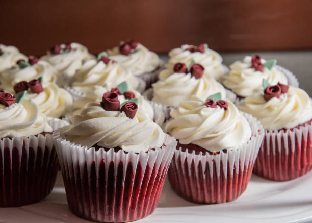 istock Red Velvet Cupakes with Rose Blossoms 867012360