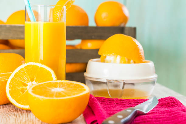 Glass of orange juice with oranges