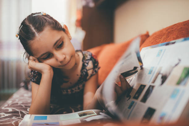 istock Beautiful little girl reading a book 867021906