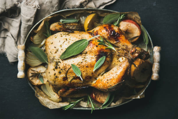 istock Oven roasted whole chicken with apples, onion and sage leaves 867023080
