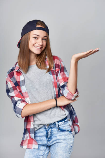 istock Teen girl showing empty copy space open hand palm 867023628