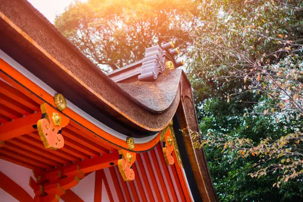 Photo of Japan style shrine red rood temple closeup rood with autumn season maple tree