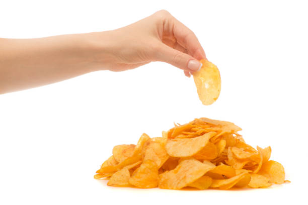 istock Chips golden snack female hand 867027792