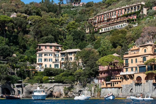 Portofino, Liguria Italia - September 3, 2017: watching the coast from the sea. View of the bay of Portofino, one of the most popular village on the Italian Riviera. Hotel Piccolo and Hotel Splendido.