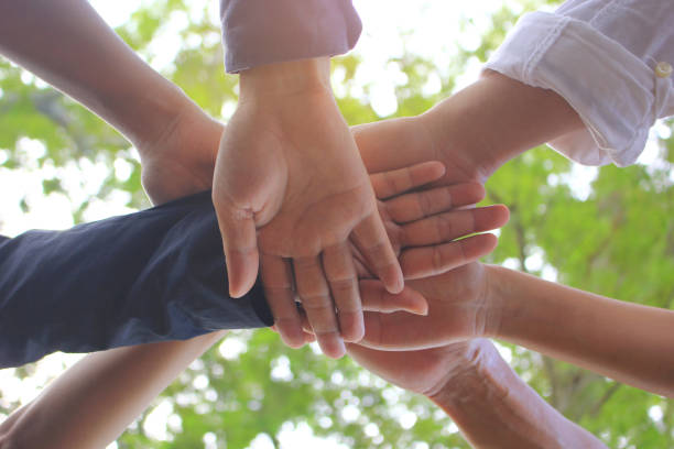 istock Meeting teamwork concept,Friendship,Group people with stack of hands showing unity on natural green background 867030832