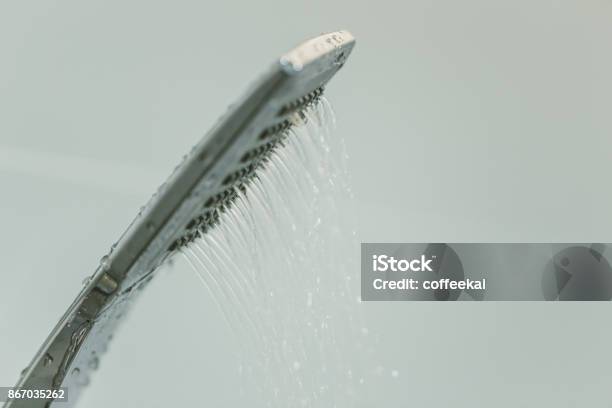 Low Water Pressure Problem Closeup At Shower Head In White Bathroom Stock Photo - Download Image Now