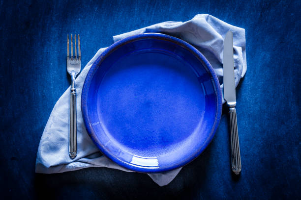 istock Blue toned place setting shot from above on dark background 867035482