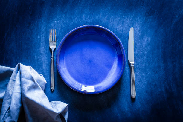 istock Blue toned place setting shot from above on dark background 867035484